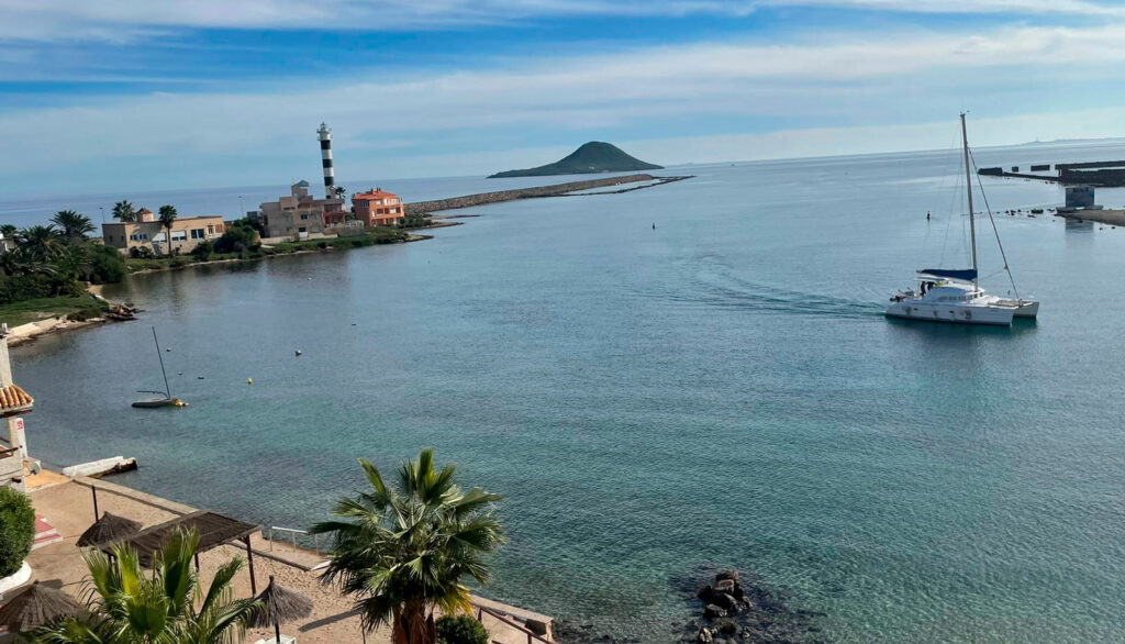 amanecer-en-el-paraiso-del-sol-viendo-el-faro-y-la-isal-grosa-con-un-barco-cruzando-por-el-canal